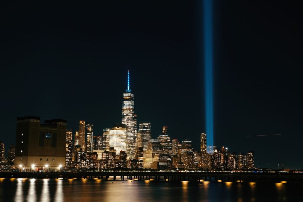 Night view of NYC skyline with the Tribute in Light shining brightly.