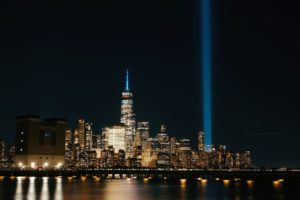 Night view of NYC skyline with the Tribute in Light shining brightly.